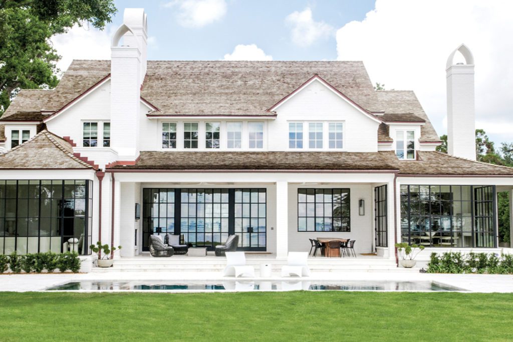 The back of this Jacksonville home is designed for living along the river, steel and glass doors blending interior to exterior