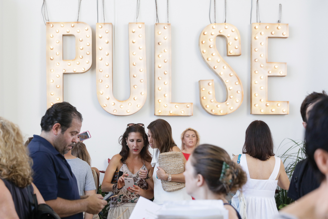 attendees gather at the entrance to the Pulse fair during Miami Art Week 2017