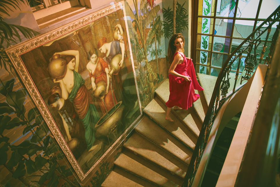 Krystoff climbs up stairs in the Versace house. 