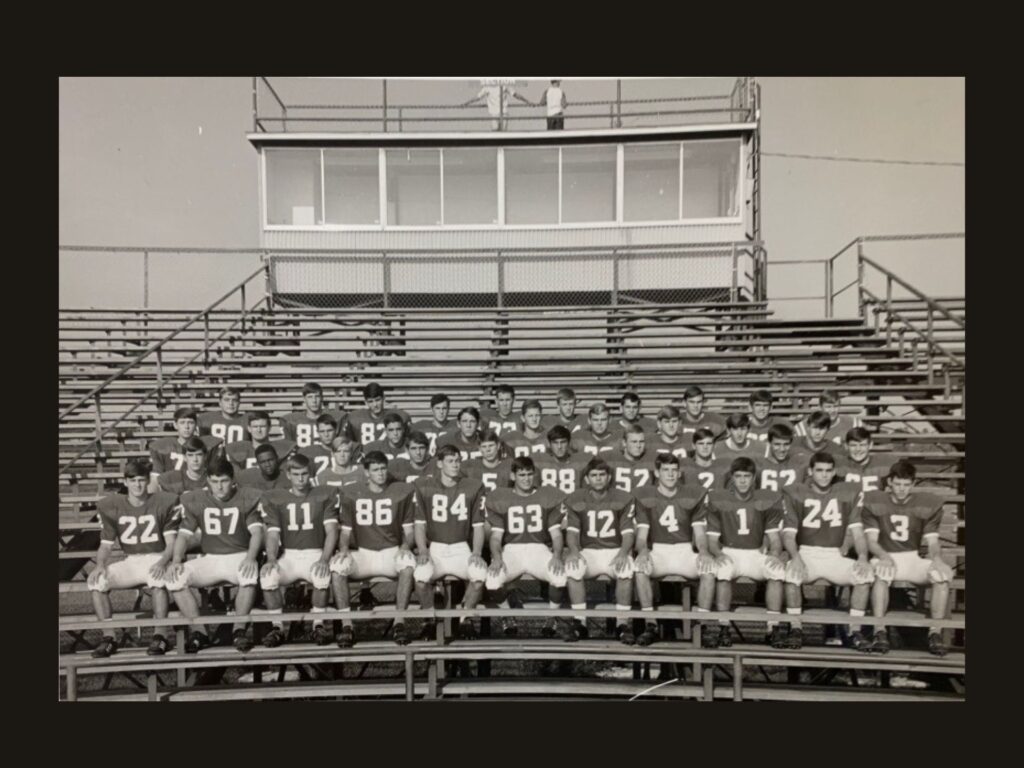 Leonard George is visible in the second row of this Jesuit High School team photo taken on the bleachers. He is the only Black player in the black and white photo.