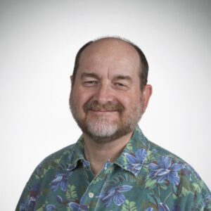 Craig Pittman in a green Hawaiian shirt with blue flowers.