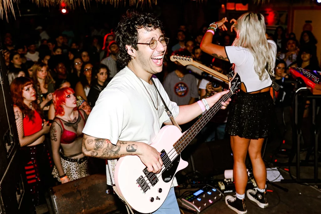 The Buko Boys are Bringing Bossa Nova Beats to Miami 2 Andy Gil shreds onstage while Raquel Lily engages with fans.